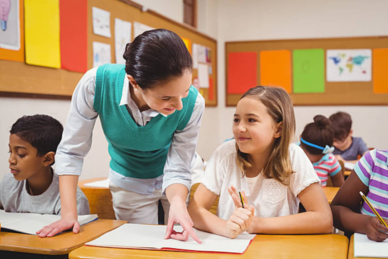 All About Tutoring teacher working with a student in class